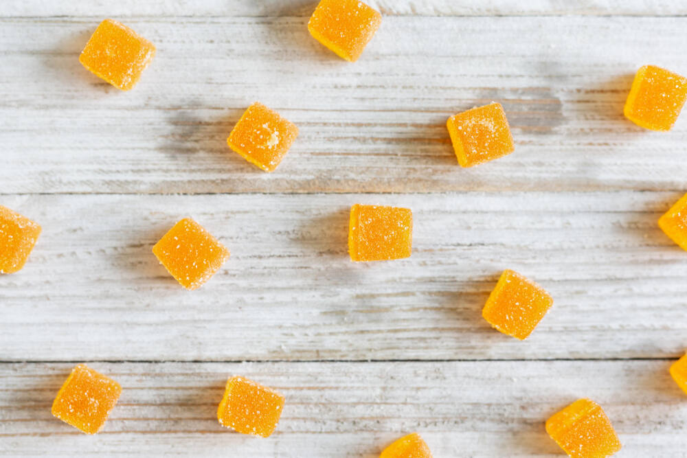 cbd gummies arranged on a white wooden table