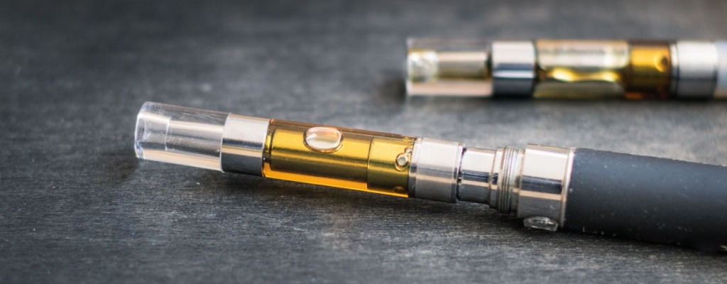 A close-up view of two vape cartridges attached to two vape batteries.