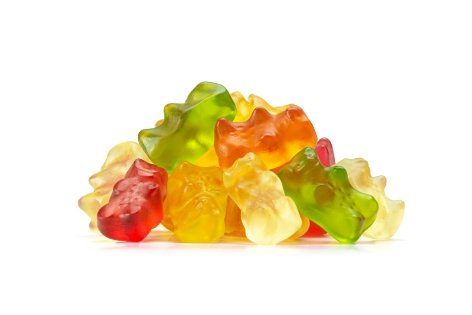 A pile of bear-shaped CBD gummies seen in front of a white background.