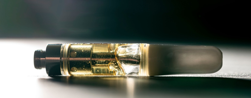 a 510 vape cartridge rests on its side on a table