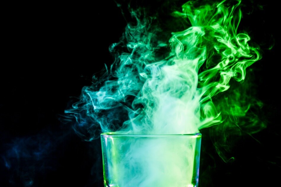 Green steam emerges from a pint glass.