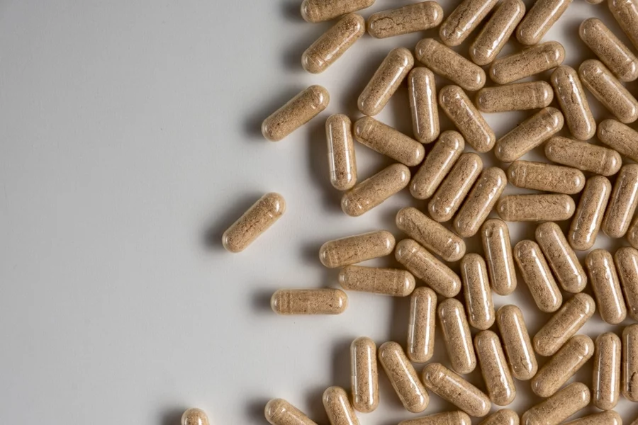 Mushroom blend capsules seen from above on a white table.