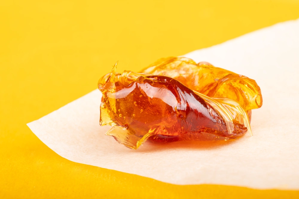 Cannabis concentrate sits on a piece of wax paper.